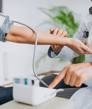 Healthcare professional checking a patient’s blood pressure